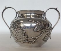 A Chinese silver sugar bowl with textured body mounted wi