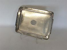 A rectangular silver engine turned dressing table tray wi