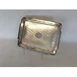 A rectangular silver engine turned dressing table tray wi
