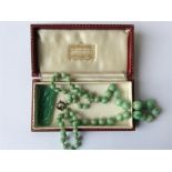 A good graduated string of jade beads with ring cl