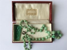 A good graduated string of jade beads with ring cl