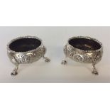 A good pair of Georgian silver embossed salts decorated w