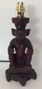 An unusual tribal table lamp in the form of monkey
