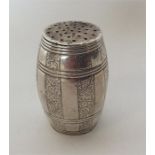 An Indian silver barrel shaped pepper with floral