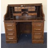 A massive oak twin pedestal cylinder top table wit