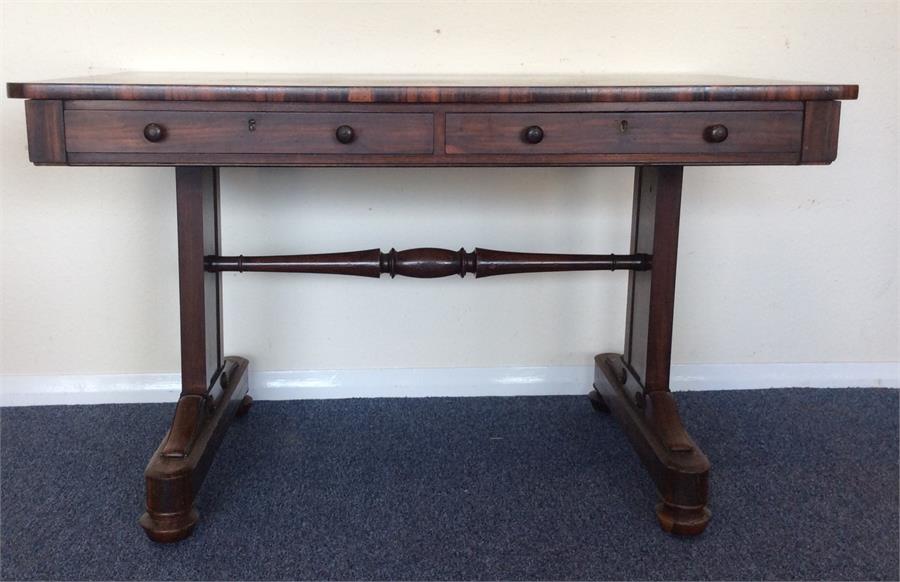 A rosewood library table with two drawers and moul
