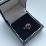 A circular Edwardian sapphire and diamond cluster