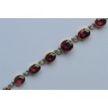 An Antique garnet and diamond necklace on fine lin