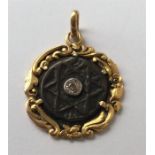 An unusual gold pendant mounted with the Jewish S