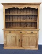 A pine three drawer dresser with shelf top. Est. £