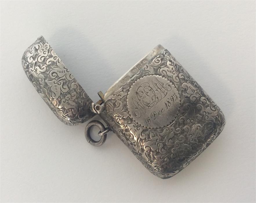 A good Edwardian silver engraved vesta case with hinged t
