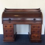 A massive mahogany twin pedestal cylinder top bure