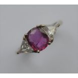 A good oval ruby and diamond three stone ring, the