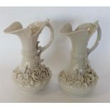 BELLEEK: A pair of decorative ewers of typical des