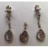 A pair of modern diamond mounted earrings together