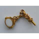 A heavy gold spinning fob together with matching k