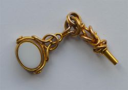 A heavy gold spinning fob together with matching k