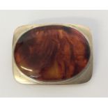 A stylish silver and amber Danish brooch. Approx.