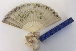 A carved ivory fan with lace and floral decoration