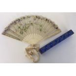 A carved ivory fan with lace and floral decoration