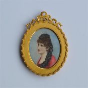 A good quality oval miniature of a lady in ribbon