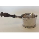 A small Queen Anne silver brandy pan on reeded bas