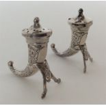 A pair of unusual horn shaped silver salts decorat