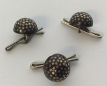 A group of three piqué buttons with star decoratio