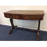 A Victorian two drawer desk on turned supports. Es