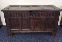 An Antique four panel coffer with hinged top and p