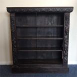 A small oak carved bookcase on pedestal base. Est.