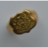 An 18 carat crested signet ring. Approx. 10 grams.