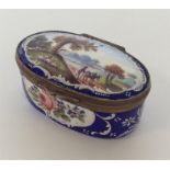 An attractive enamelled pill box with brass mounts