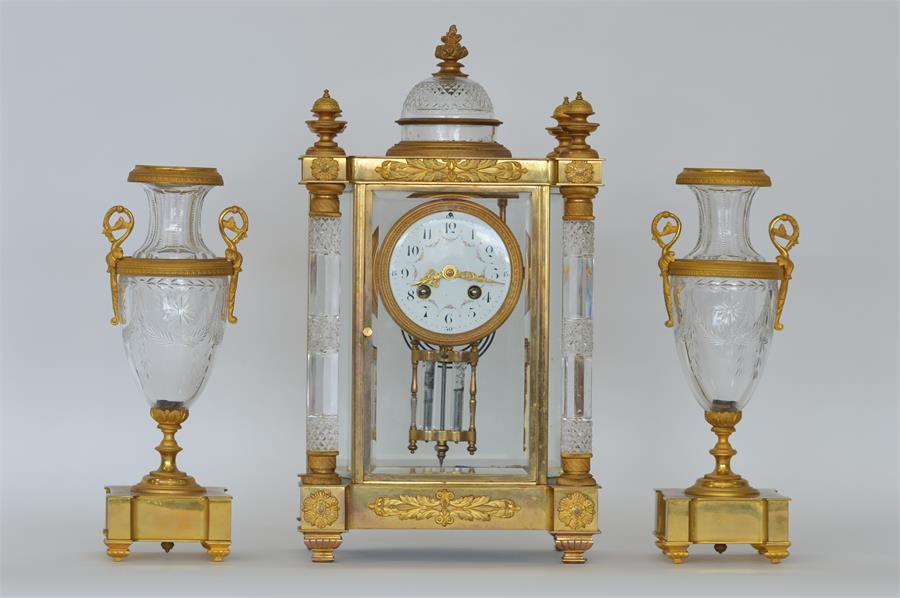A good quality French clock garniture with white e