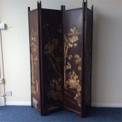 An Oriental four-fold screen decorated with figure