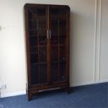 A stylish oak two door bookcase with cut corners.