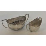 A small half fluted silver cream and sugar bowl. Sheffiel