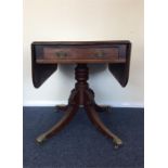 A mahogany single pedestal breakfast table with dr