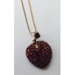 An Antique garnet mounted heart shaped pendant wit