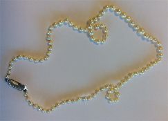 A good string of graduated pearl beads within a sc