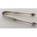 A pair of bright cut silver sugar tongs of typical design