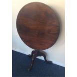 A Georgian mahogany circular tilt top table. Est.