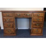 A burr walnut twin pedestal writing desk with leat