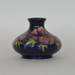 MOORCROFT: A modern blue ground vase decorated wit