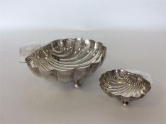 A large silver shell sweet dish together with a similar s