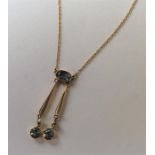 An Aquamarine and pearl drop pendant in 15 carat s