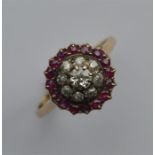 A circular ruby and diamond cluster ring in gold m