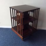 A good Edwardian cross banded revolving bookcase w