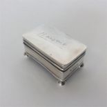 A small rectangular silver ring box with hinged cover and