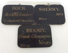A group of three unusual wooden bin labels depicti